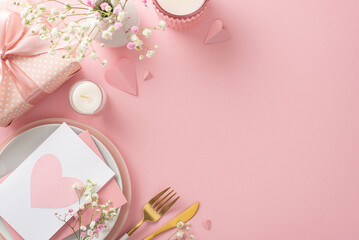 Mother's day brunch setting concept. Top view flat lay of plates, cutlery, tulips, gift box, vase, postal card, decorative hearts on pastel pink background with a space for promotional content or text