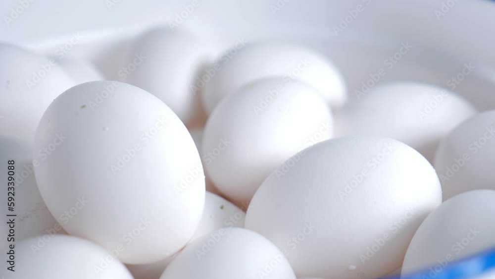 Lots of white fresh chicken raw eggs in basket. Sliding camera movement. Egg production. Eggs in restaurant ready to be used in cooking. 4 k video Lots of white fresh chicken raw eggs in basket. Sliding camera movement. Egg production. Eggs in restaurant ready to be used in cooking. 4 k video