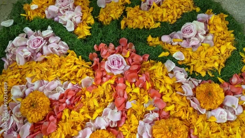 Close-up view of a beautiful floral mandala. Handmade circle pattern made from live flowers on the floor as hindu and buddhist sign. Film grain pixel texture. Soft focus. Live camera. Blur. photo