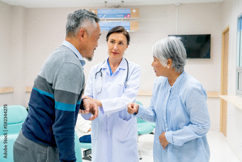 Close up of Caucasian doctor woman help to consult and give suggestion to senior man and woman in front of pharmacy counter in hospital. Close up of Caucasian doctor woman help to consult and give suggestion to senior man and woman in front of pharmacy counter in hospital.