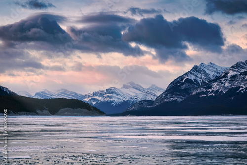 Sunrise over rocky mountains and frozen lake in Abraham Lake at Jasper national park