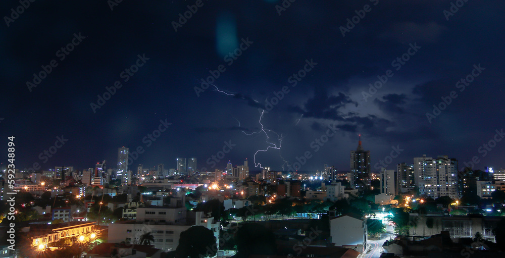 Thunderstorm with lightning in a cloudy sky over the high buildings of city SANTA CRUZ DE LA SIERRA - BOLIVIA