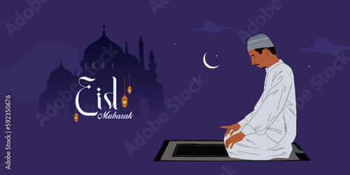 Religious Muslim young man praying in front of mosque on night background for holy month of Muslim community Ramadan Kareem.