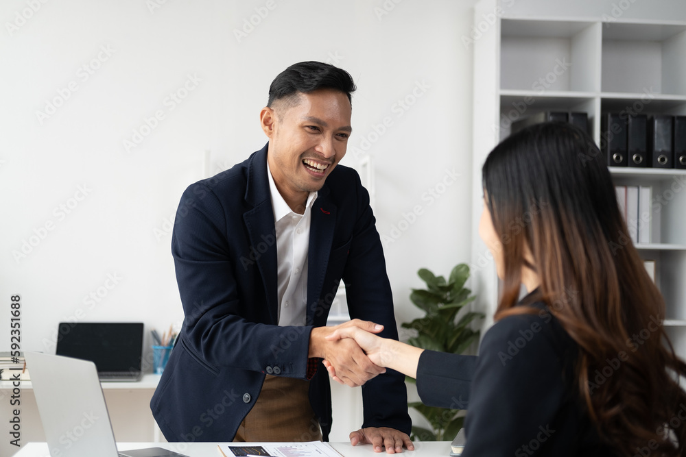 Young business people shaking hands in the office. Finishing successful meeting. Young business people shaking hands in the office. Finishing successful meeting.