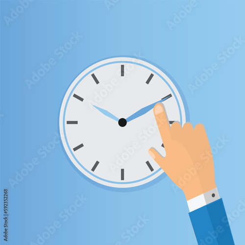 Clock face with index finger on a clock hand