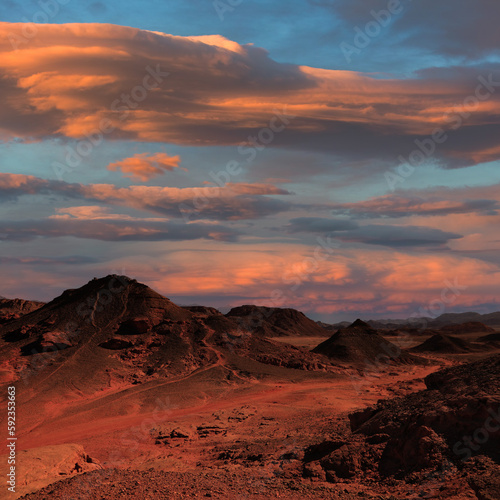 Sunrise over rocky desert and distant mountains in the wild. Wonderful world. Environment protection © Alexey Protasov