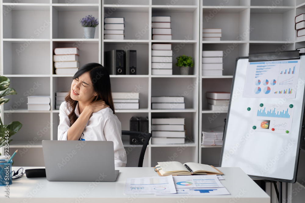 Asian businesswomen suffer from shoulder pain from working too much in an office. Asian businesswomen suffer from shoulder pain from working too much in an office.