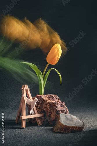 concept spring. freakebana. Trendy card with yellow tulip and hummingbird. Creative image of flowers with blurred trail, fantasy motion effect, long exposure, motion blur photo