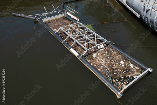 Floating rubbish barges are being used by the City of Melbourne, Australia, to stop litter washing into the Yarra River at Docklands photo