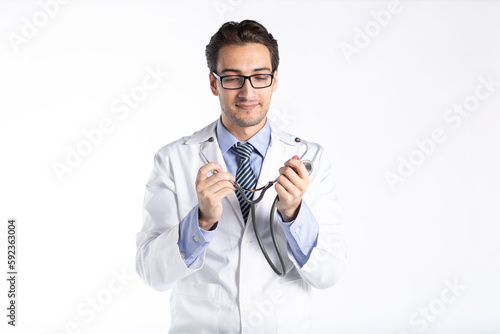 Portrait of young handsome doctor in medical gown and stethoscope isolated on white background 