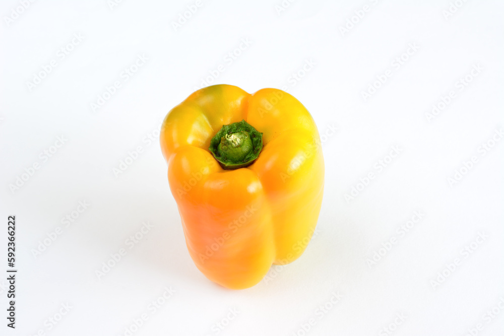 A yellow pepper with a green stem is on a white background isolated A yellow pepper with a green stem is on a white background isolated