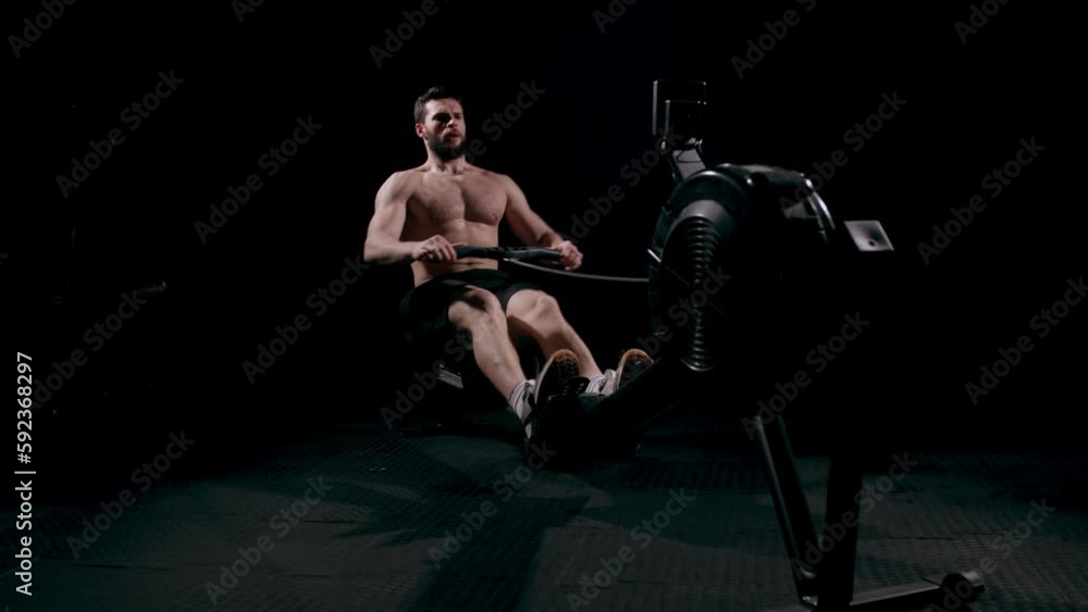 Exercise bike, fitness and sweat with a man athlete in a gym for a cardiovascular workout. Elliptical machine and breathing with a male cycling to increase health, cardio or endurance Exercise bike, fitness and sweat with a man athlete in a gym for a cardiovascular workout. Elliptical machine and breathing with a male cycling to increase health, cardio or endurance