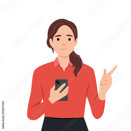 Smiling young woman hold cellphone point at screen. Happy girl with smartphone in hands show with finger at camera make choice