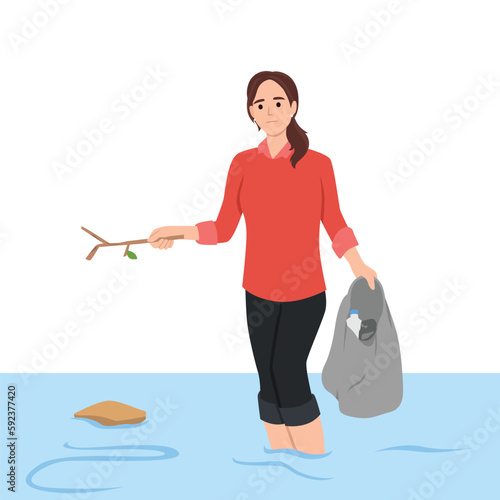 Sad woman cleans ocean of plastic garbage by pulling out bottles using scoop-net. Girl eco activist and volunteer to take care of nature puts garbage thrown into sea into bag