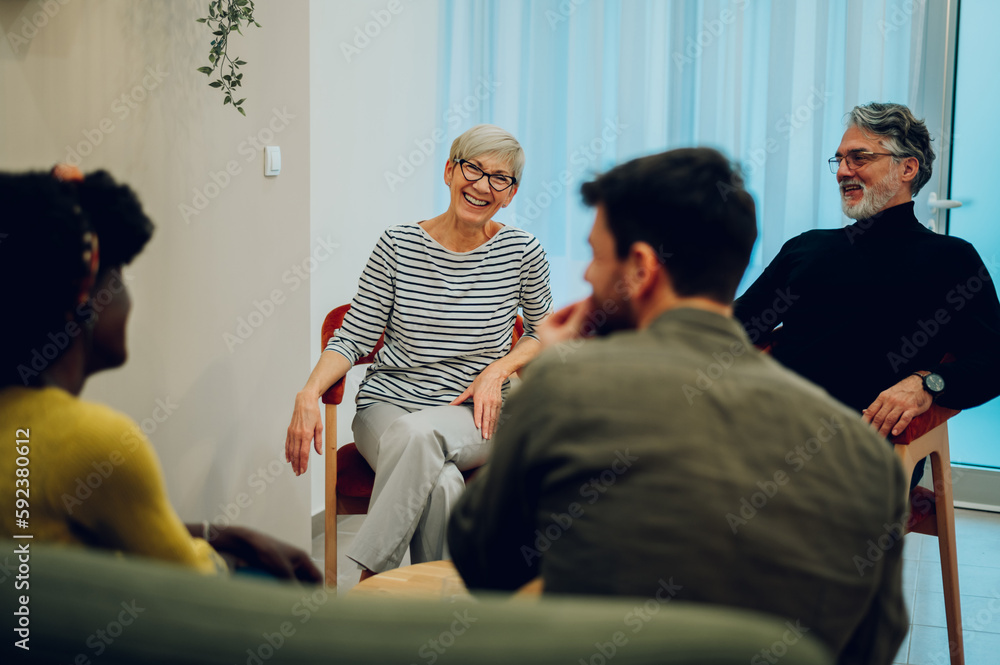Obraz premium Senior woman talking about her mental health on a group therapy session