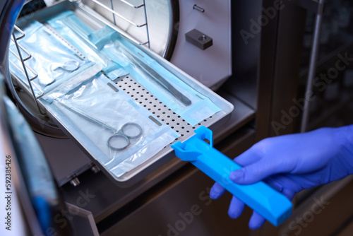 Cropped photo the process of sterilizing medical instruments in an autoclave photo