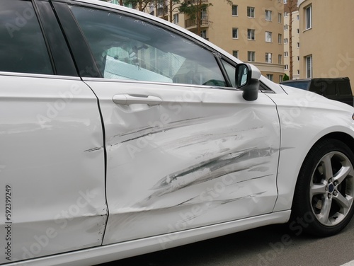 Canvas Print Dent on front right door white car.