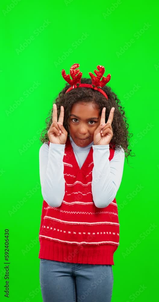Christmas, green screen and child with peace sign for happy festive season, holiday or celebration with red nose. Oops, chroma key portrait and female kid with emoji icon gesture on studio background Christmas, green screen and child with peace sign for happy festive season, holiday or celebration with red nose. Oops, chroma key portrait and female kid with emoji icon gesture on studio background