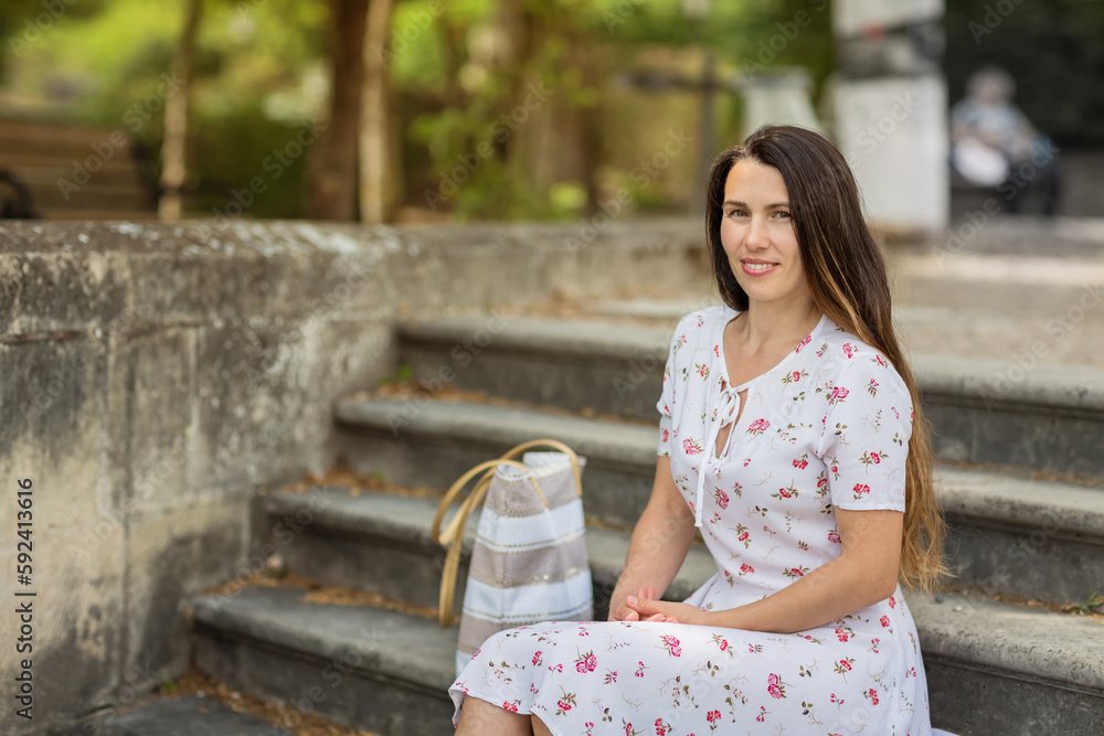 Pretty woman sitting and posing on ancient stone stairs Pretty woman sitting and posing on ancient stone stairs