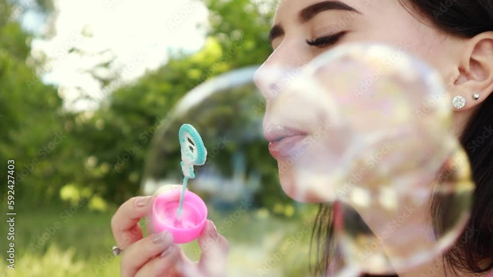 Woman sitting on white bedsheet, blowing soap bubbles, smiling. Lady have a rest in the city park, green grass lawn. Travel, vacation, picnic set
Woman sitting on white bedsheet, blowing soap bubbles, smiling. Lady have a rest in the city park, green grass lawn. Travel, vacation, picnic set