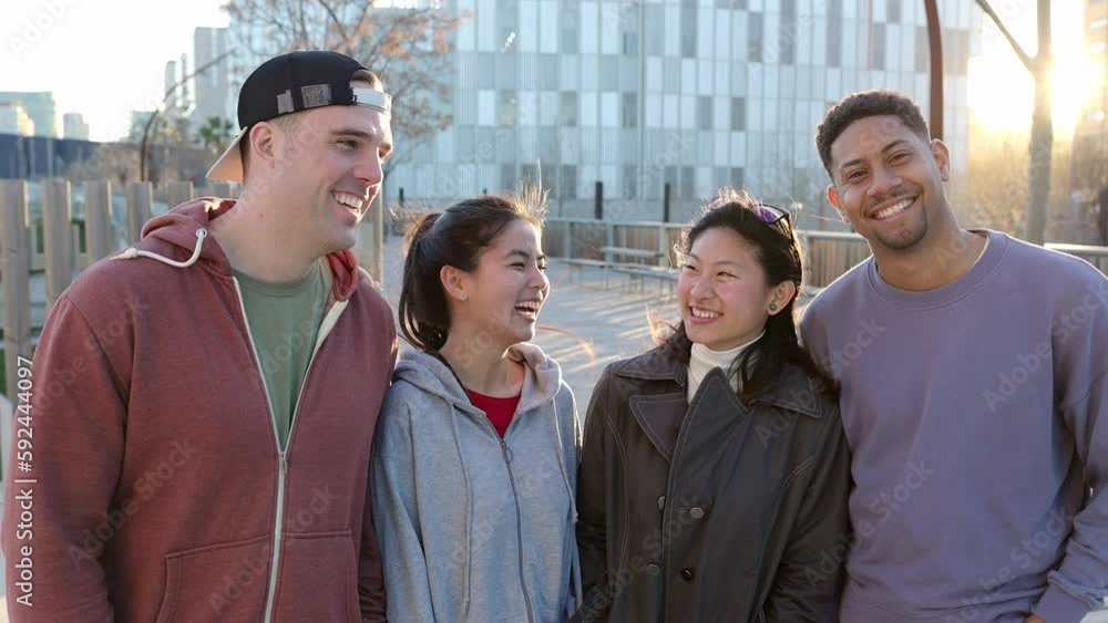 Happy portrait of young group of diverse friends embracing each other ...