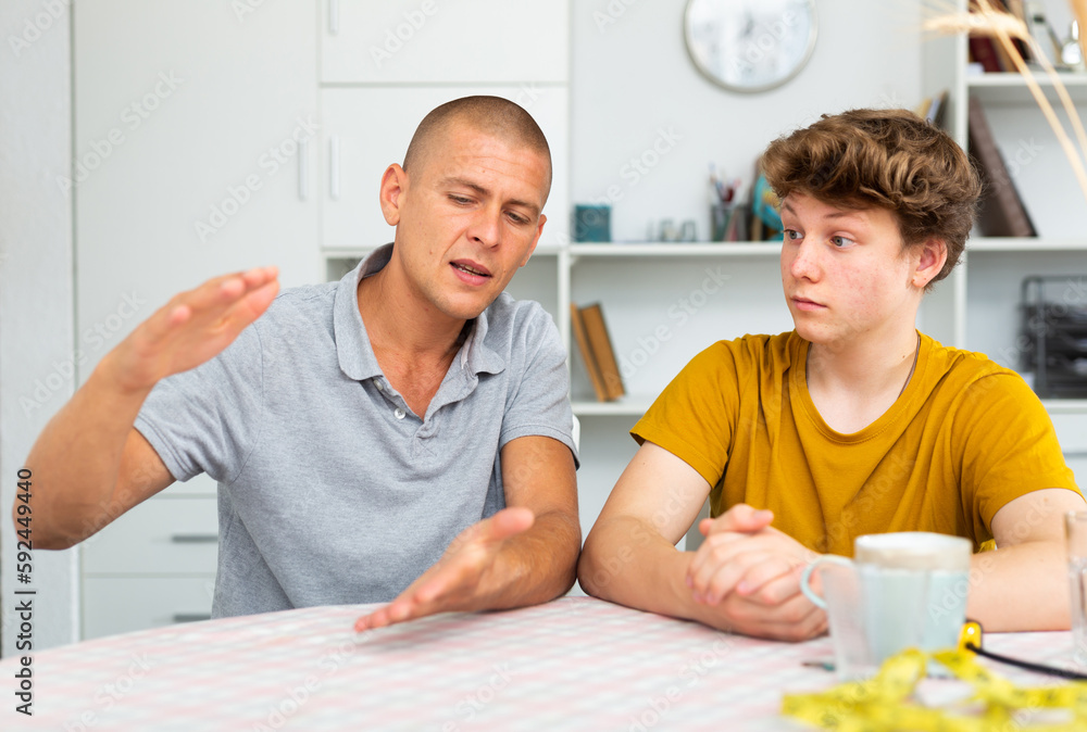 Man with his son are talking about life together at the home