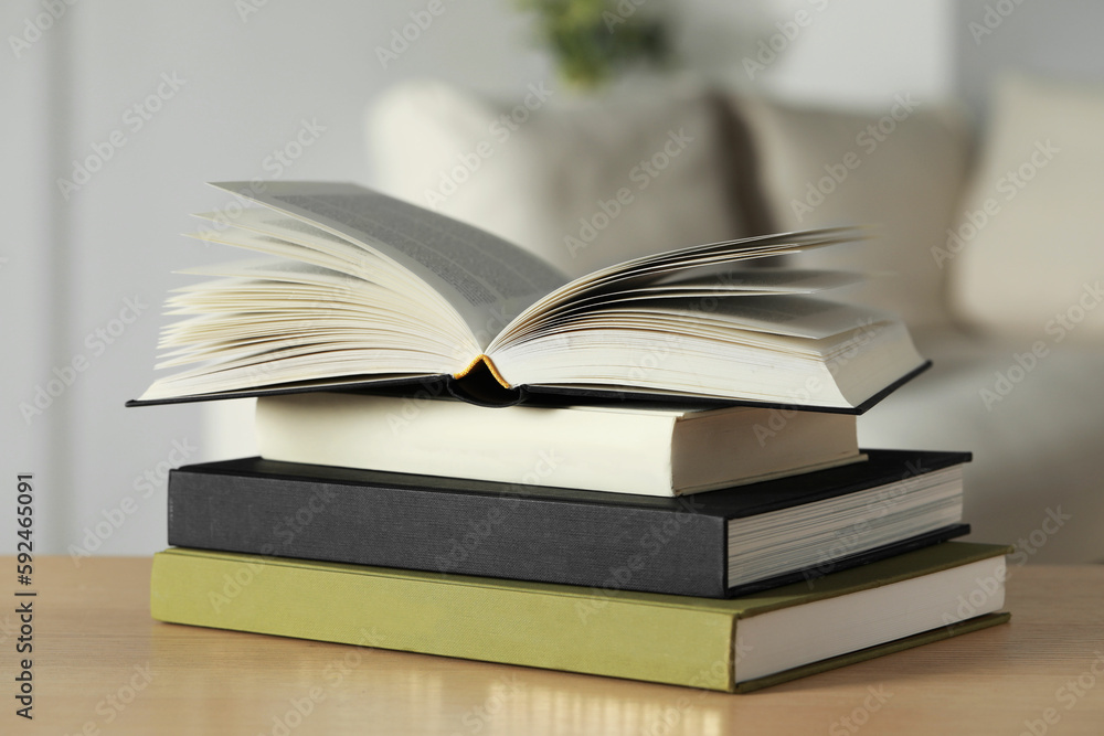Stack of hardcover books on wooden table indoors, closeup Stack of hardcover books on wooden table indoors, closeup