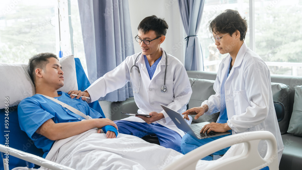 Obraz premium The medical team visits the car accident patients who are lying on the nursing bed and arm cast with wrapping nurse bandages splint to the arm.