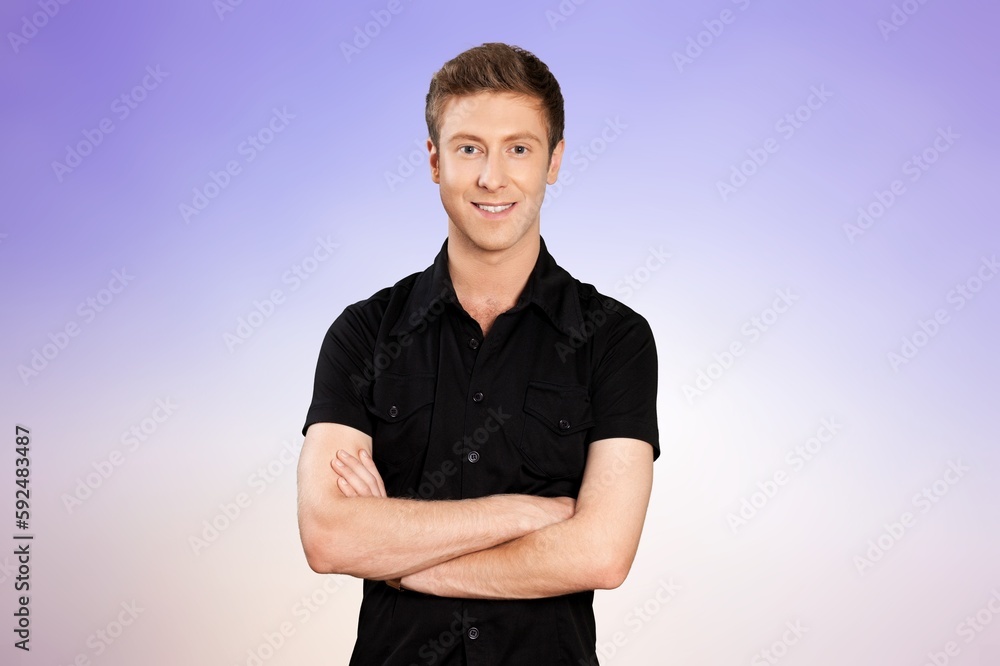 Happy young man standing with crossed arms Happy young man standing with crossed arms