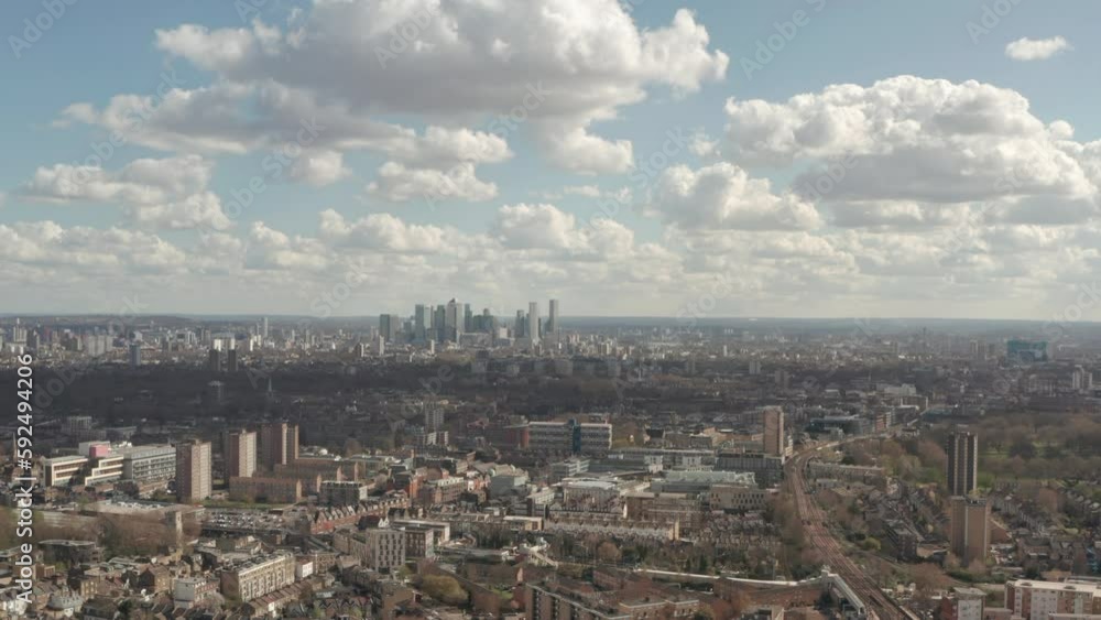 Rising aerial shot of Canary Wharf from Hackney central east London Rising aerial shot of Canary Wharf from Hackney central east London