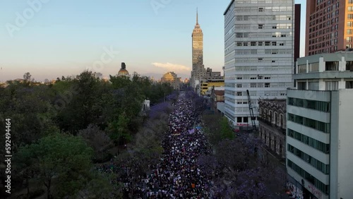 Aerial view of a feminist protest parade in Mexico city, during sunset photo