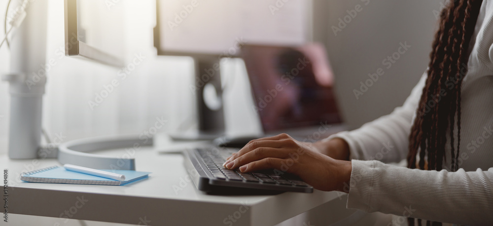 Close up shot of happy young woman working on computer, female hands typing on keyboard Close up shot of happy young woman working on computer, female hands typing on keyboard