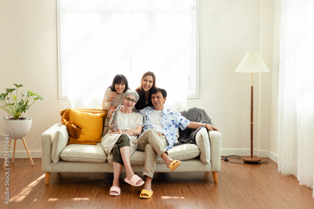 happy family Asian family, parents and children Happy sitting on the sofa in the house. The family relaxes on the sofa in the living room. happy family happy family Asian family, parents and children Happy sitting on the sofa in the house. The family relaxes on the sofa in the living room. happy family