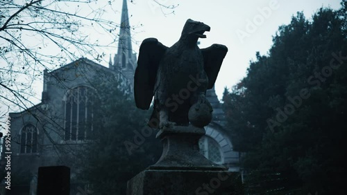 Eagle tombstone sculpture in a gothic cemetery photo