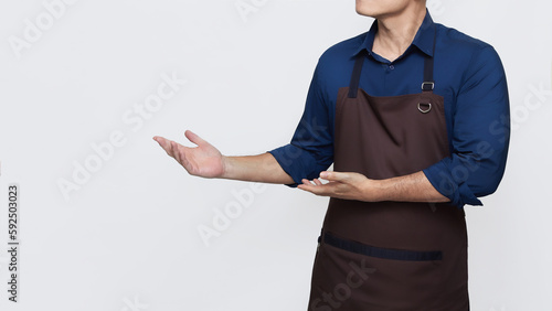 Asian Man wearing Apron in casual stylish clothing, standing tall welcoming pose with both hands showing something, no face isolated white background