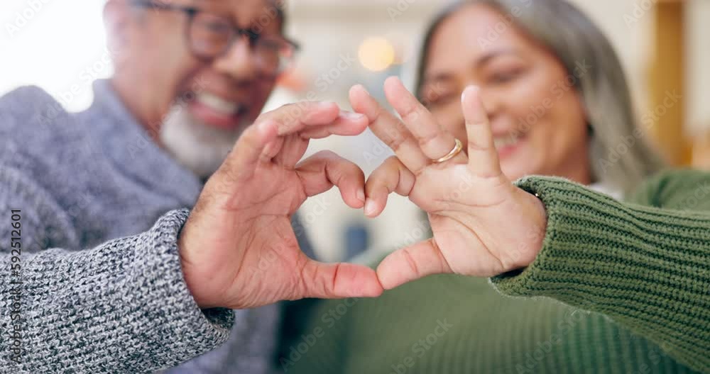 Heart, hands and couple in home for love, kindness and commitment to life partner, relationship and sign. Closeup man, happy woman and finger shape of care, support and trust of hope, peace and emoji Heart, hands and couple in home for love, kindness and commitment to life partner, relationship and sign. Closeup man, happy woman and finger shape of care, support and trust of hope, peace and emoji