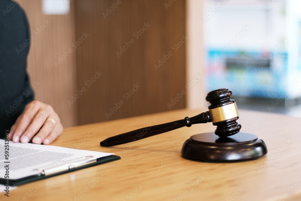 Legal counsel presents to the client a signed contract with gavel and legal law. justice and lawyer concept. Legal counsel presents to the client a signed contract with gavel and legal law. justice and lawyer concept.