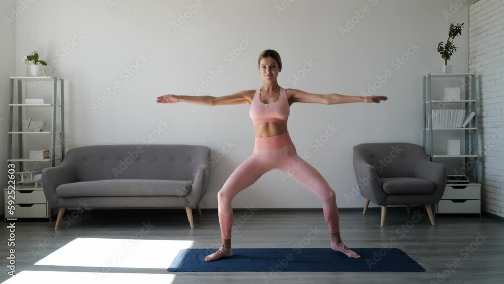 Young woman in sport style doing exercise stretching at home. Sexy girl practices in ballet choreography. Sporty athletic slim fitness woman. Wellness, healthy lifestyle. Sport and recreation concept. Young woman in sport style doing exercise stretching at home. Sexy girl practices in ballet choreography. Sporty athletic slim fitness woman. Wellness, healthy lifestyle. Sport and recreation concept.