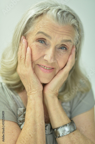 Portrait of beautiful old woman posing at home