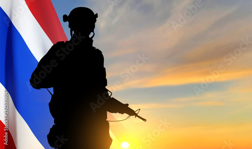 Silhouette of a soldier with Thai flag against the sunset. Patriotic concept. EPS10 vector
