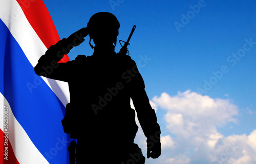 Silhouette of a soldier with Thai flag on background of sky. Patriotic concept. EPS10 vector