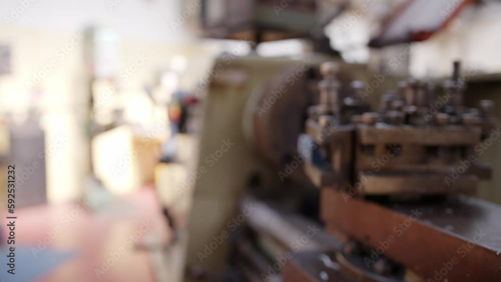Slider shot of a metal turning lathe. Framing moves from the chuck, spindle and head stock to the tool post. Iron or steel metal shavings are visible. Shot in Stornoway on the Isle of Lewis, Hebrides. Slider shot of a metal turning lathe. Framing moves from the chuck, spindle and head stock to the tool post. Iron or steel metal shavings are visible. Shot in Stornoway on the Isle of Lewis, Hebrides.