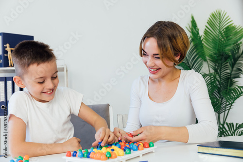 female psychologist develops boy fine motor skills development learning