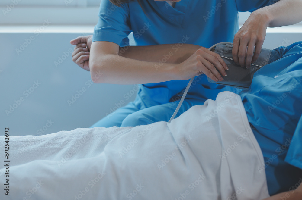Injured patient showing doctor broken wrist and arm with bandage in hospital office or emergency room. Sprain, stress fracture or repetitive strain injury in hand. Nurse helping customer. First aid.