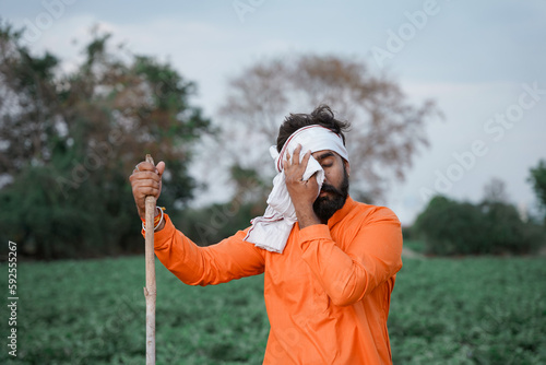 Young indian farmer working at field