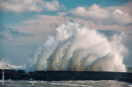 Huge wave crashing on the pier on a sunny stormy day 