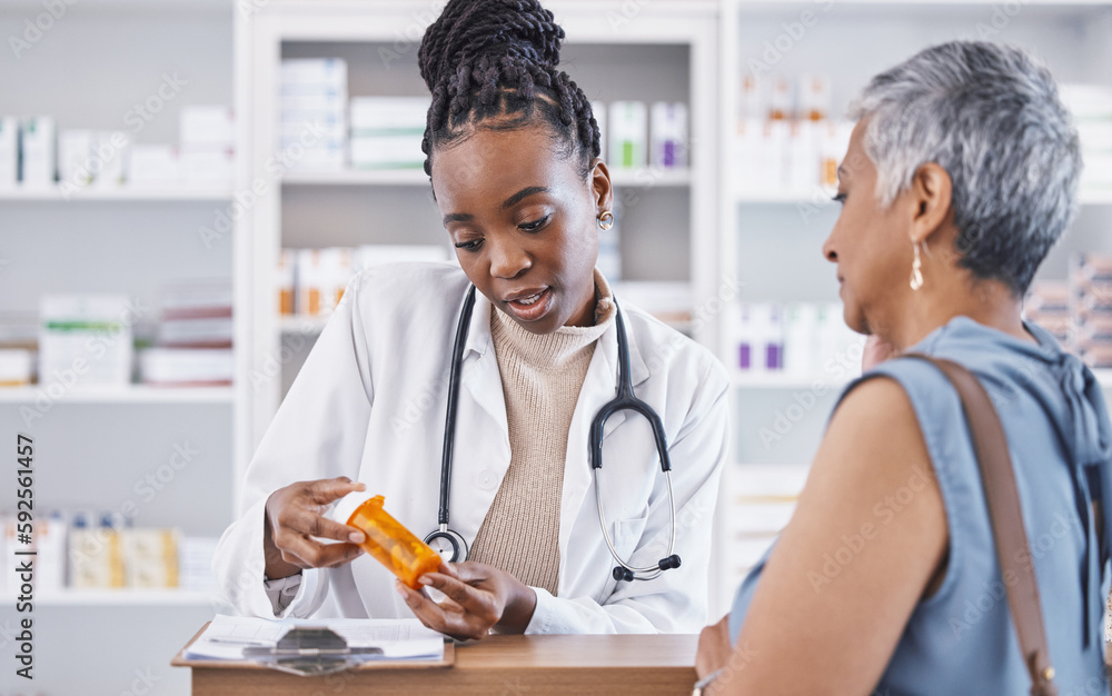 © C. Davids/peopleimages.com - Black woman, doctor and prescription medication for patient or over the counter pills at pharmacy. African medical pharmacist consulting senior client for dosage, symptoms or side effects at clinic