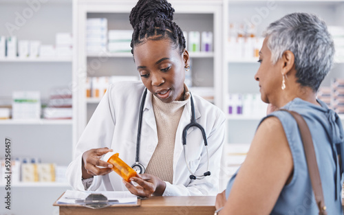 Black woman, doctor and prescription medication for patient or over the counter pills at pharmacy. African medical pharmacist consulting senior client for dosage, symptoms or side effects at clinic