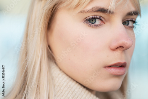 Close up portrait of young woman with blue eyes.