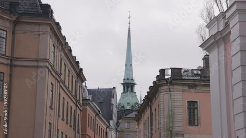 St. Gertrude's Church Spire At The Narrow Street In Gamla Stan, Old Town In Central Stockholm, Sweden. Low Angle photo